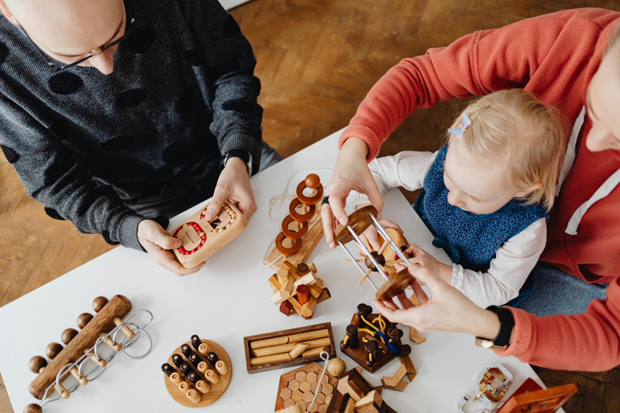 Family engaging in educational play with wooden puzzles. Perfect for learning and bonding.